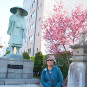 Woman in front of a Cherry Blossom Tree
