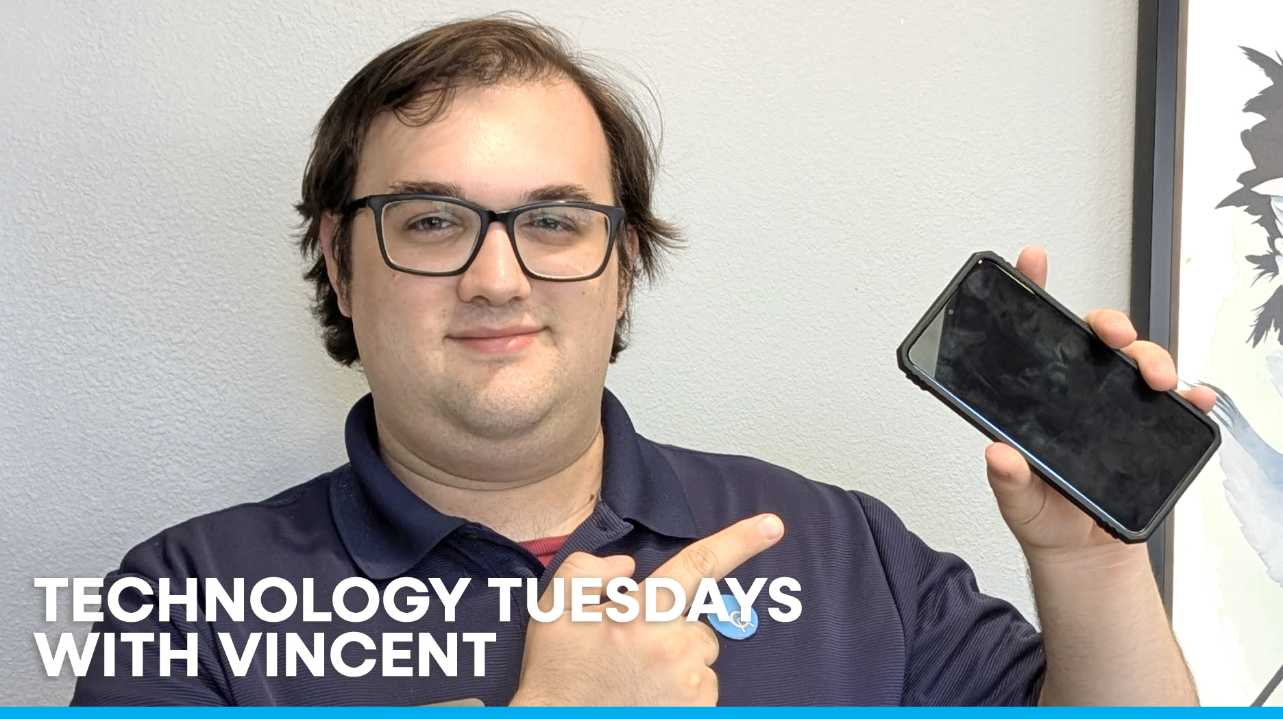 Technology Tuesdays With Vincent - Man with glasses pointing at a cell phone