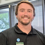 Cole Bauer. Man standing wearing a black shirt.