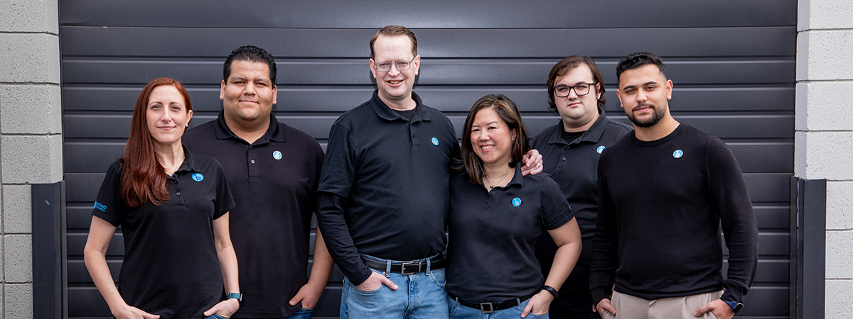 Photo of 6 members of the Beyond Accessible team - two females and four males in black logoed shirts.