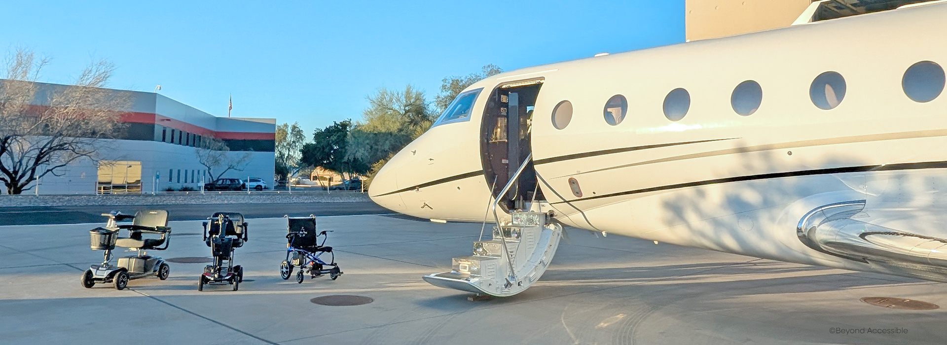 Two scooters and a powerchair parked next to an airplane