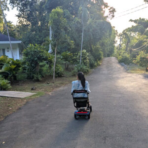 woman on a scooter on a road in Jamaica