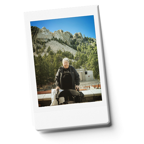 Mary using a Nova gemini rollator in front of Mount Rushmore.