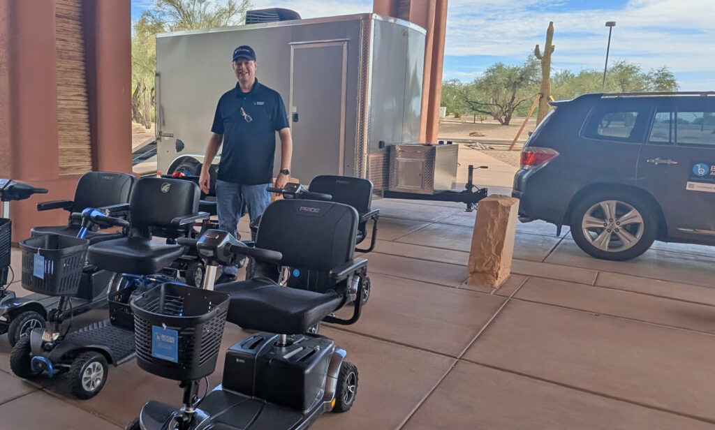Scooters and a man in front of the Cargo Trailer